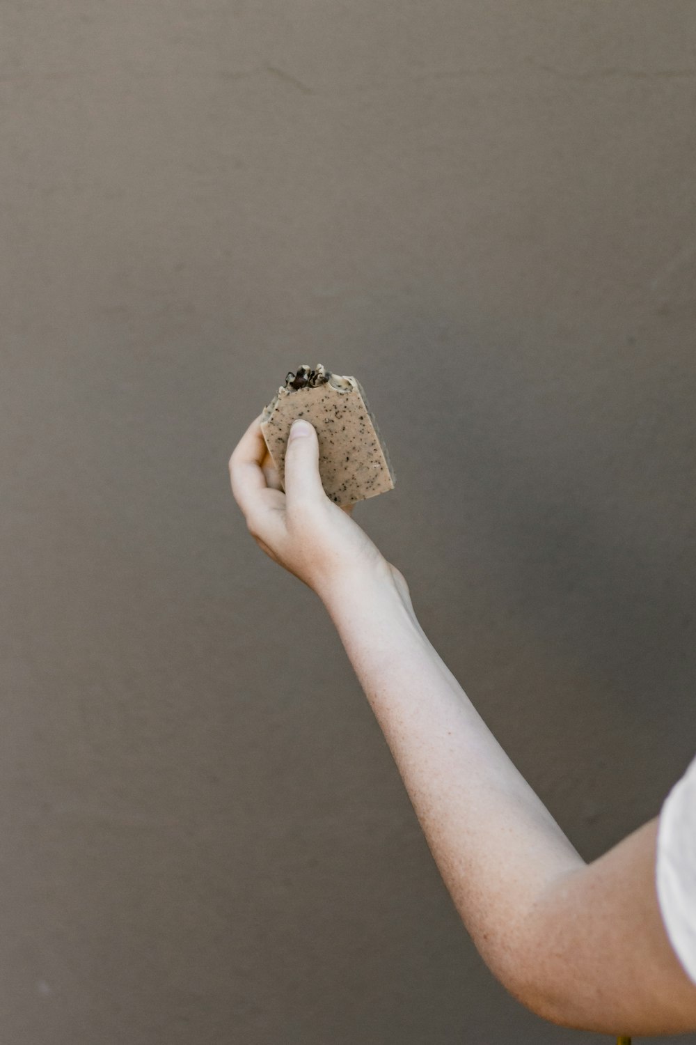 person holding brown and black textile