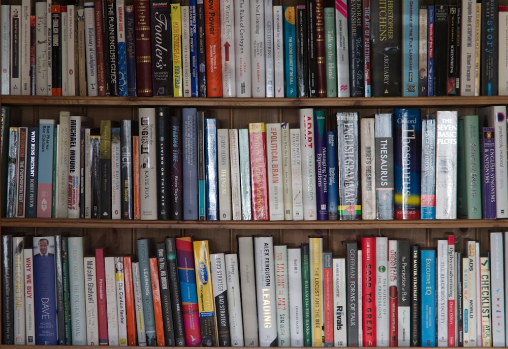 books on brown wooden shelf