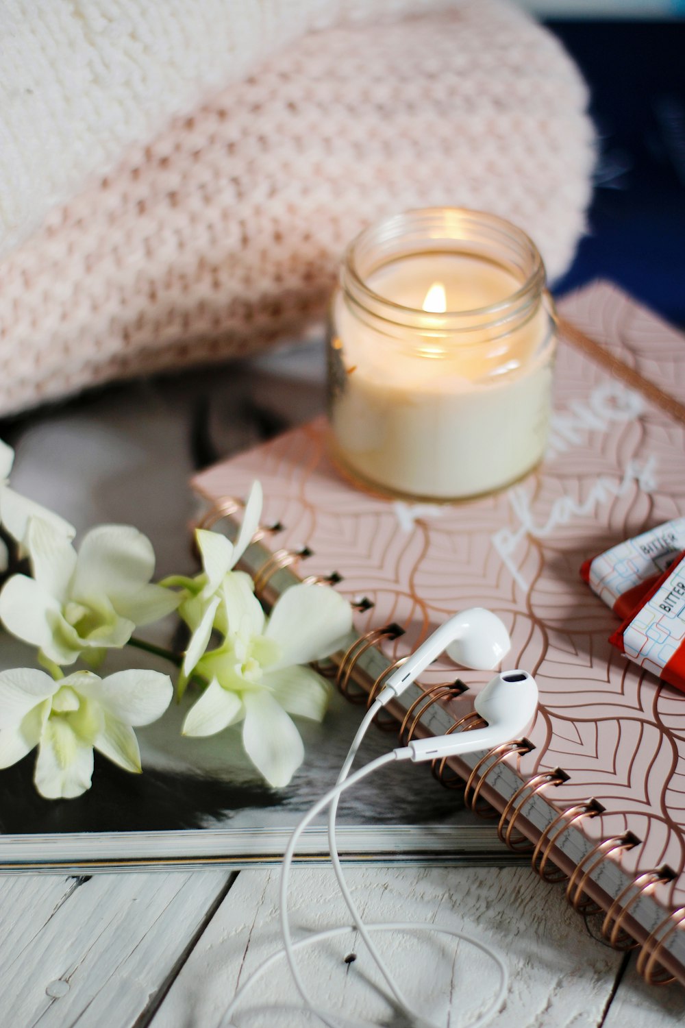 white apple earpods beside white flower