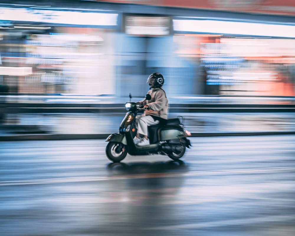 man riding motorcycle in time lapse photography