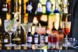 clear cocktail glass with pink liquid inside