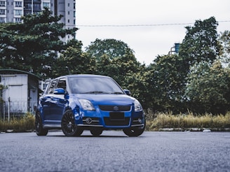 blue bmw m 3 parked on gray asphalt road during daytime