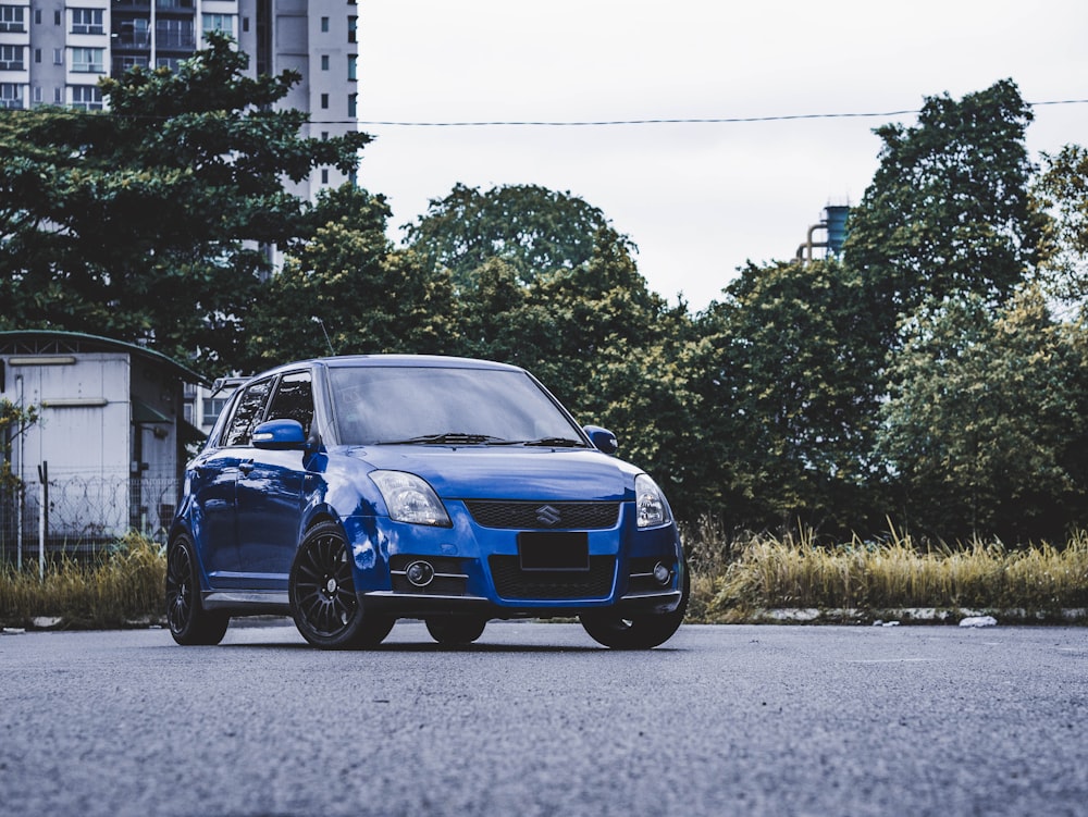 blue bmw m 3 parked on gray asphalt road during daytime