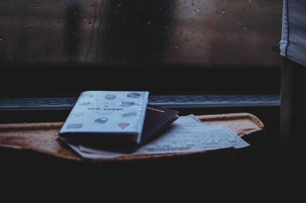 white book on brown wooden table