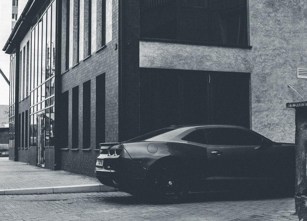 black porsche 911 parked beside building