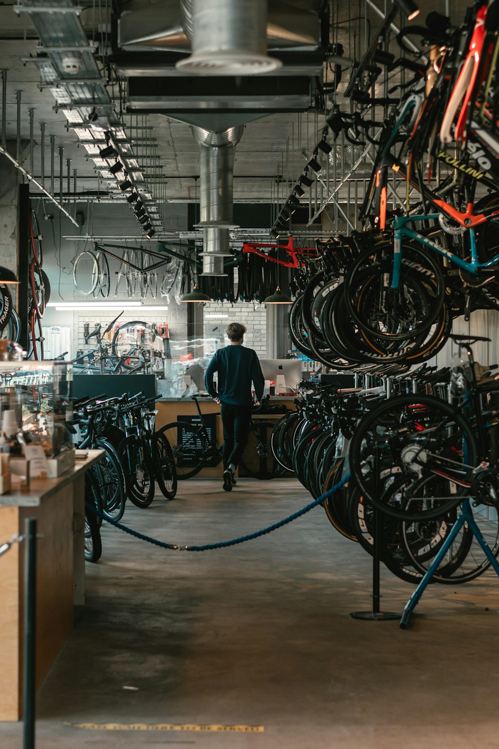 man in black t-shirt standing near black and red bicycle