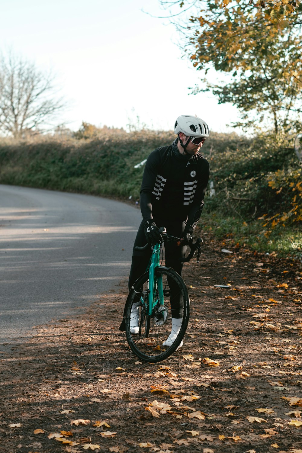 man in black jacket riding bicycle on road during daytime