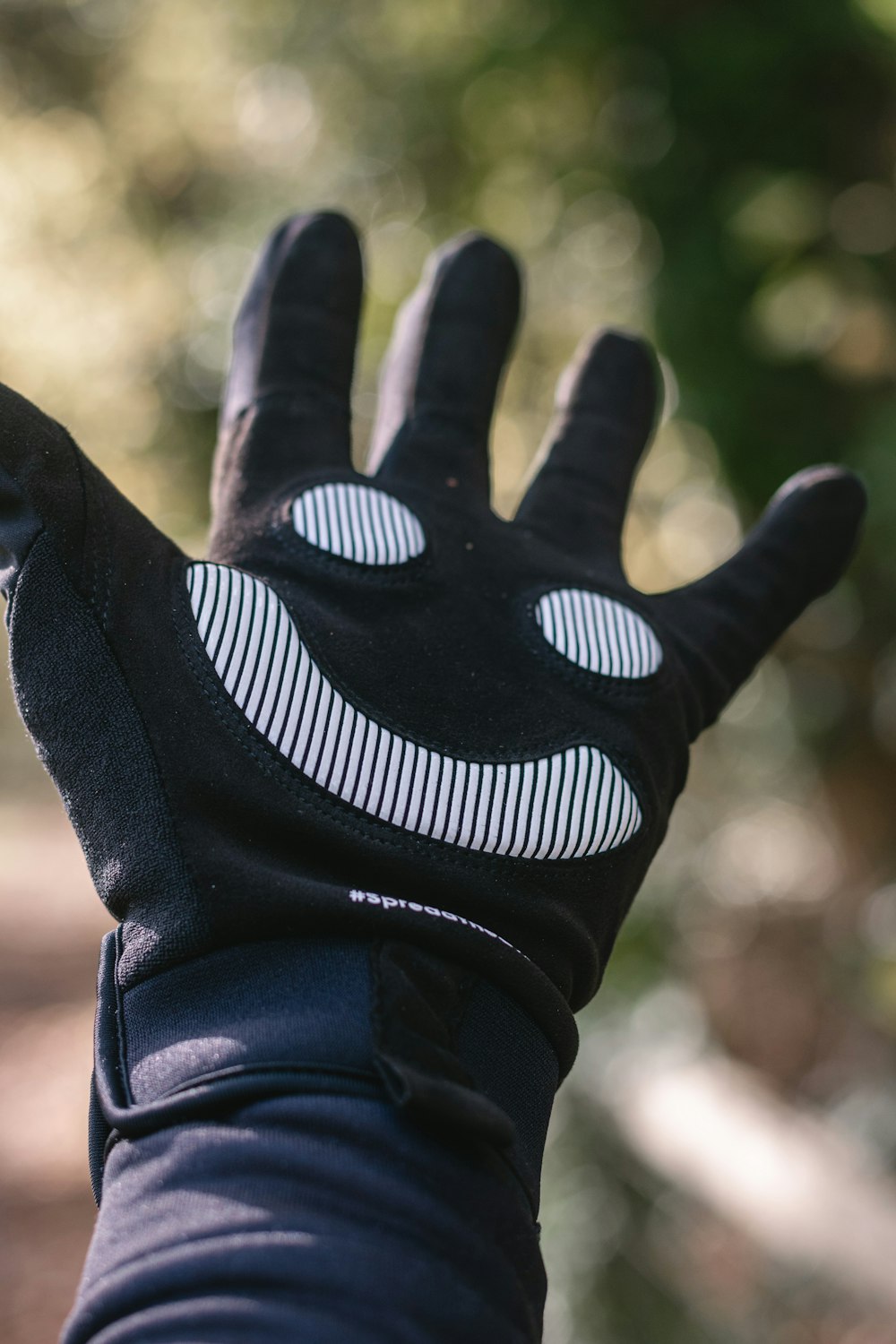 person wearing black and white nike gloves