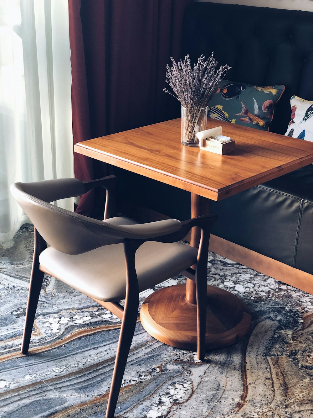 brown wooden table with black leather padded chairs