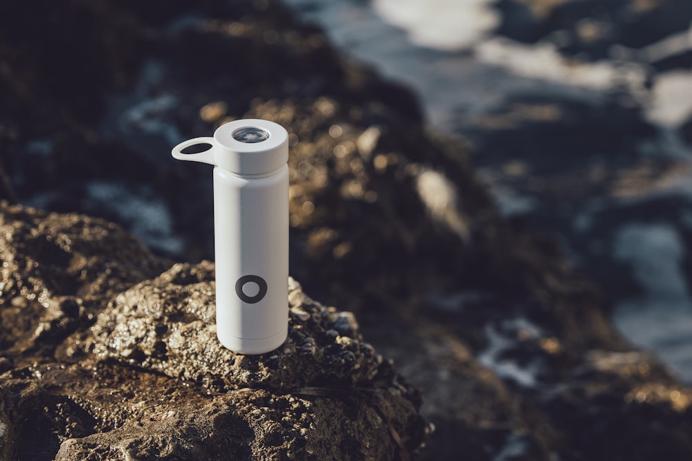 white plastic pitcher on brown rock