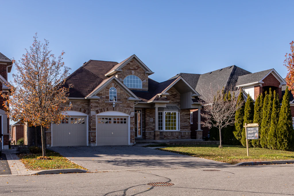 Two-story home with neutral siding and front porch in Brighton