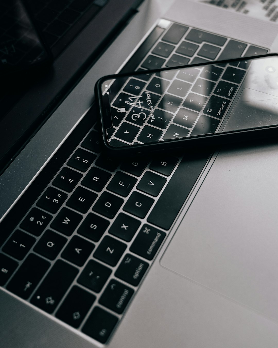 black iphone 7 on white laptop computer