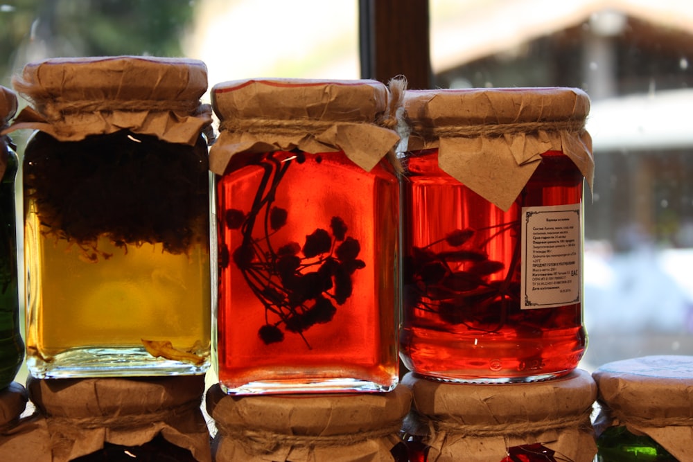 clear glass jars with red liquid inside