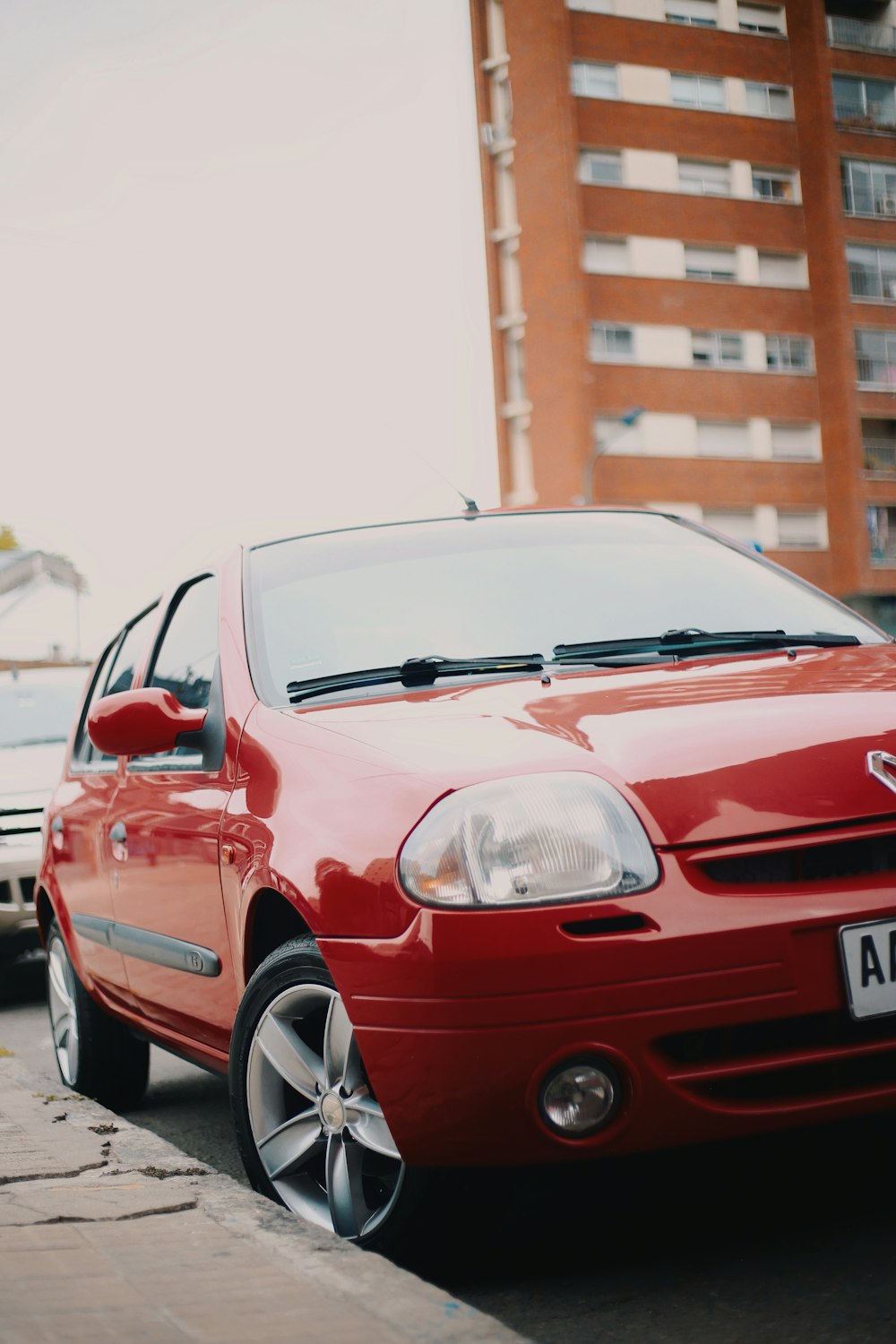 red bmw m 3 parked on street during daytime