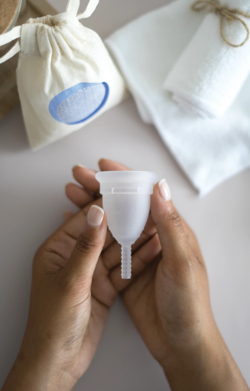 A silicone menstrual cup on a plain background