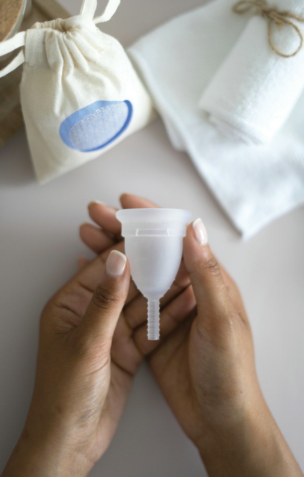 person holding white plastic cup