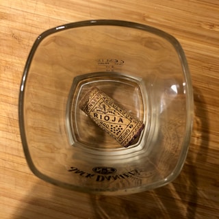Close-up of a colorful 'Rioja and Roll' branded t-shirt on a wooden table.