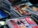 A collection of stacked compact discs (CDs) with colorful album covers, including one prominent with psychedelic art. The CDs are arranged haphazardly, suggesting a music collection. The visible album cover depicts vivid floral and band imagery, hinting at classic rock music.