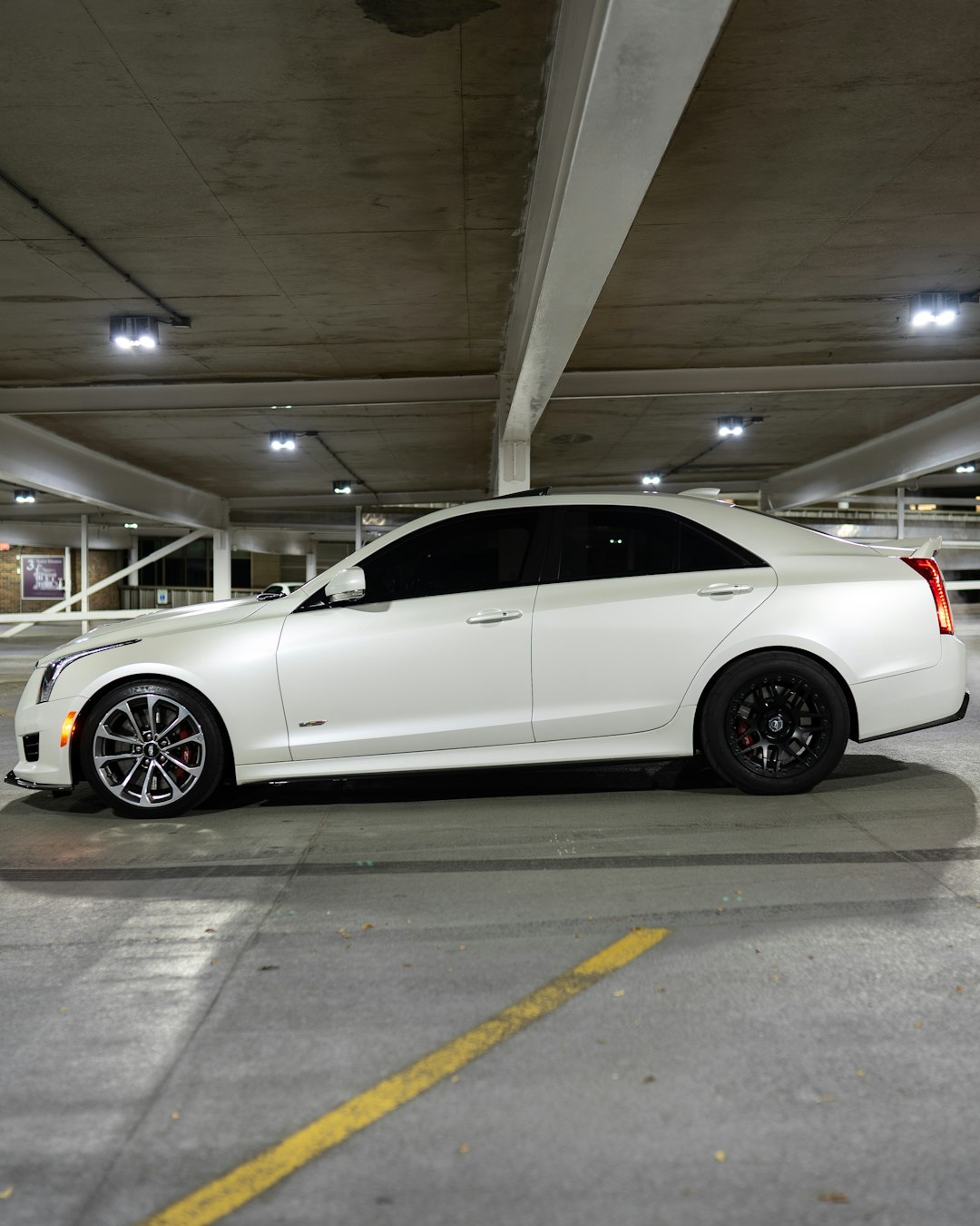 white sedan parked on parking lot