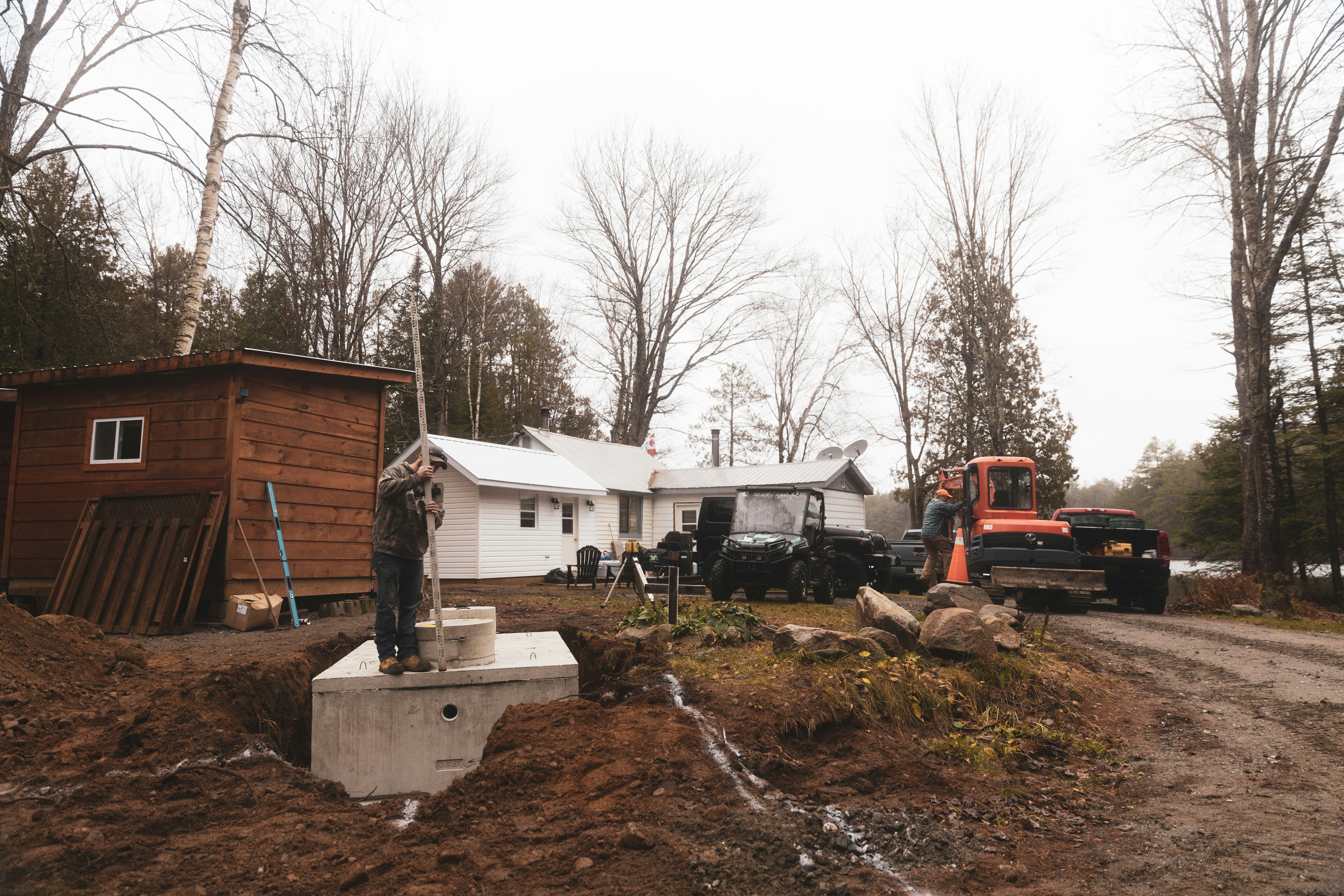 white and brown wooden house near bare trees during daytime