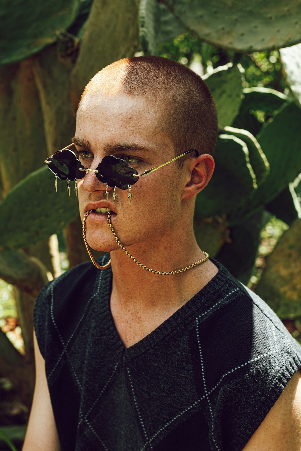 man in black v neck shirt wearing black sunglasses