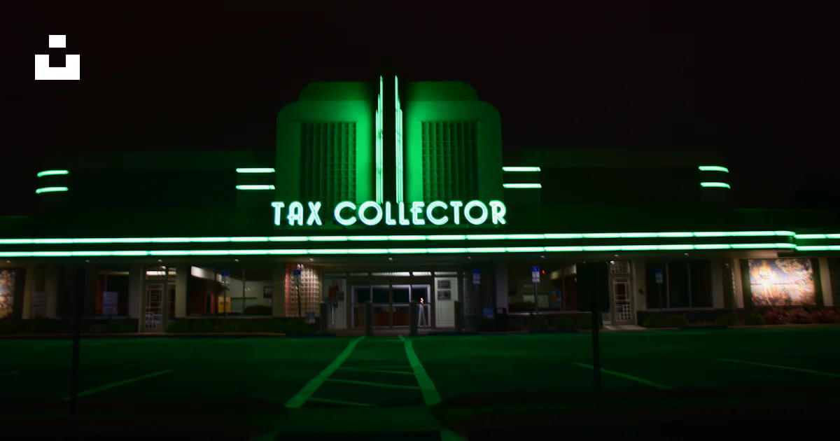 A large building with a neon sign that says tax collector photo – Free ...