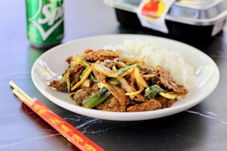 cooked rice with green vegetable on white ceramic plate