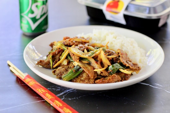 cooked rice with green vegetable on white ceramic plate
