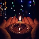 lighted candle on brown round holder