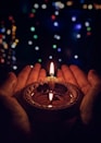 lighted candle on brown round holder
