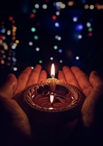 lighted candle on brown round holder