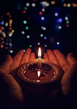 lighted candle on brown round holder