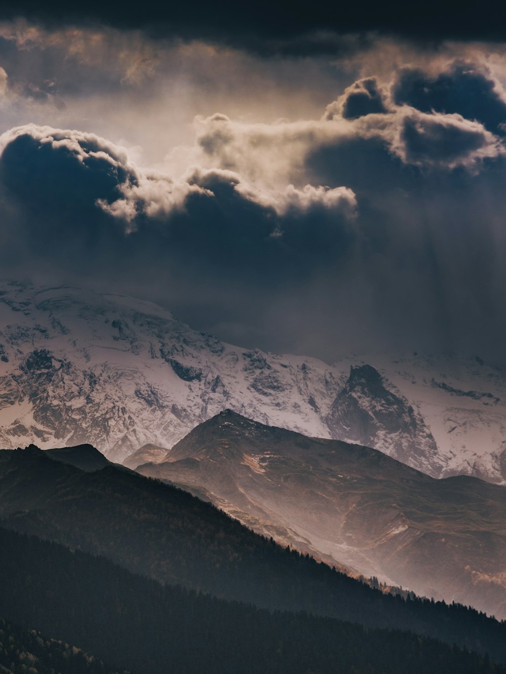 snow covered mountain under cloudy sky during daytime