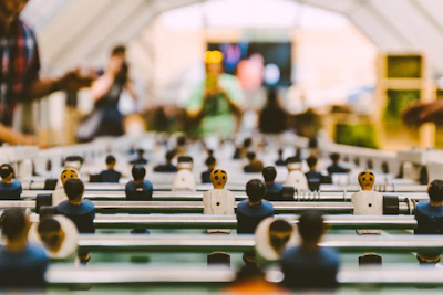 Dynamic scene showing foosball players battling on the field with animated effects highlighting the action.