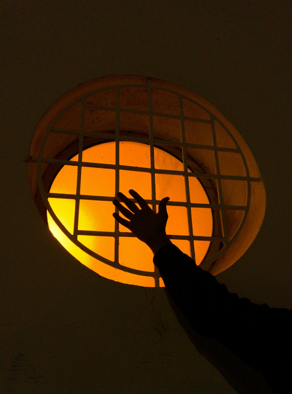 person holding brown round lantern