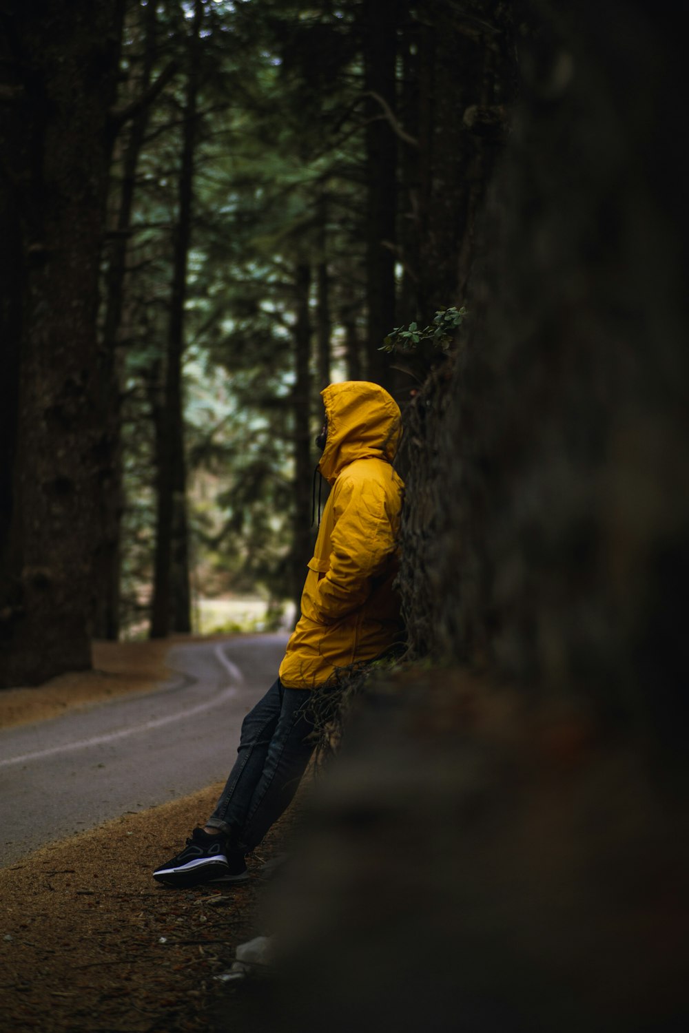 person in yellow hoodie walking on road during daytime