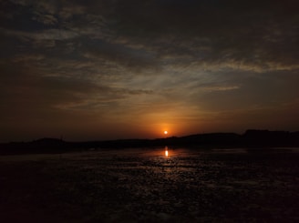 A serene landscape with a sunset casting warm hues.