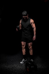 man in black tank top and shorts wearing black mask