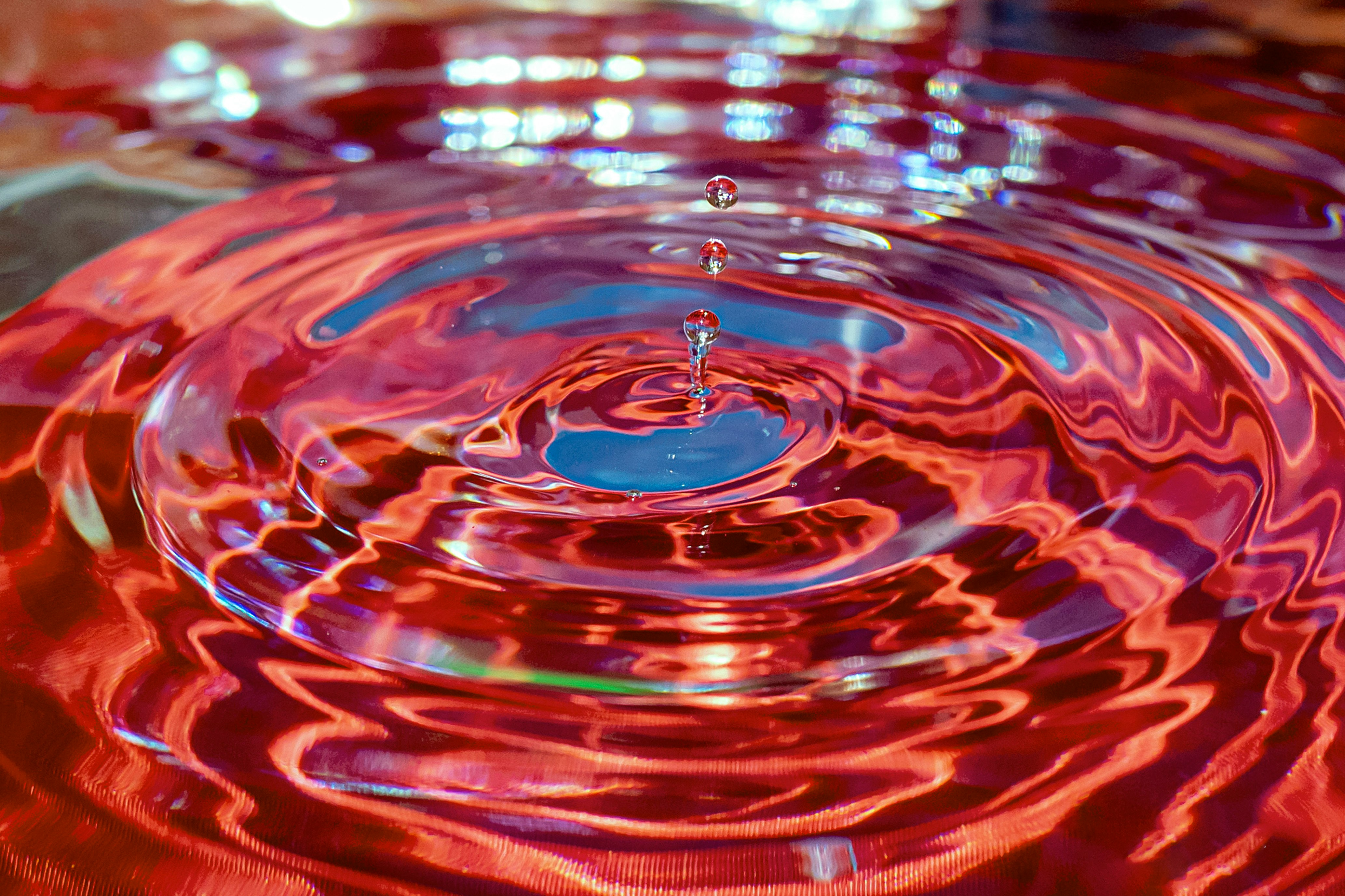water drop on red surface