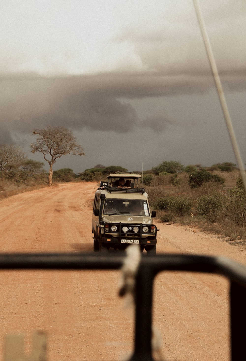 black suv on dirt road during daytime