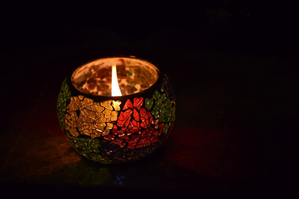 lighted candle in glass holder