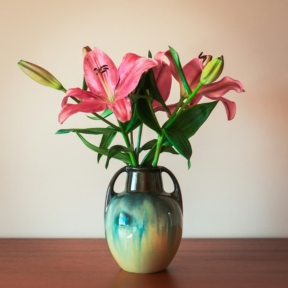 purple flowers in blue glass vase