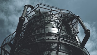 black metal spiral staircase under blue sky during daytime