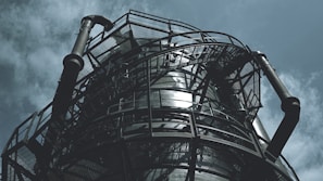 black metal spiral staircase under blue sky during daytime