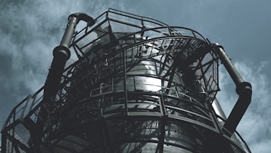 black metal spiral staircase under blue sky during daytime
