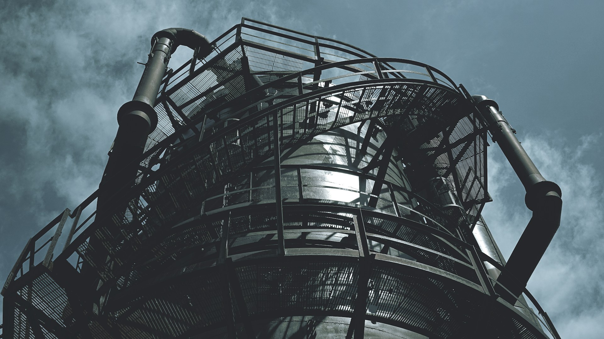 black metal spiral staircase under blue sky during daytime