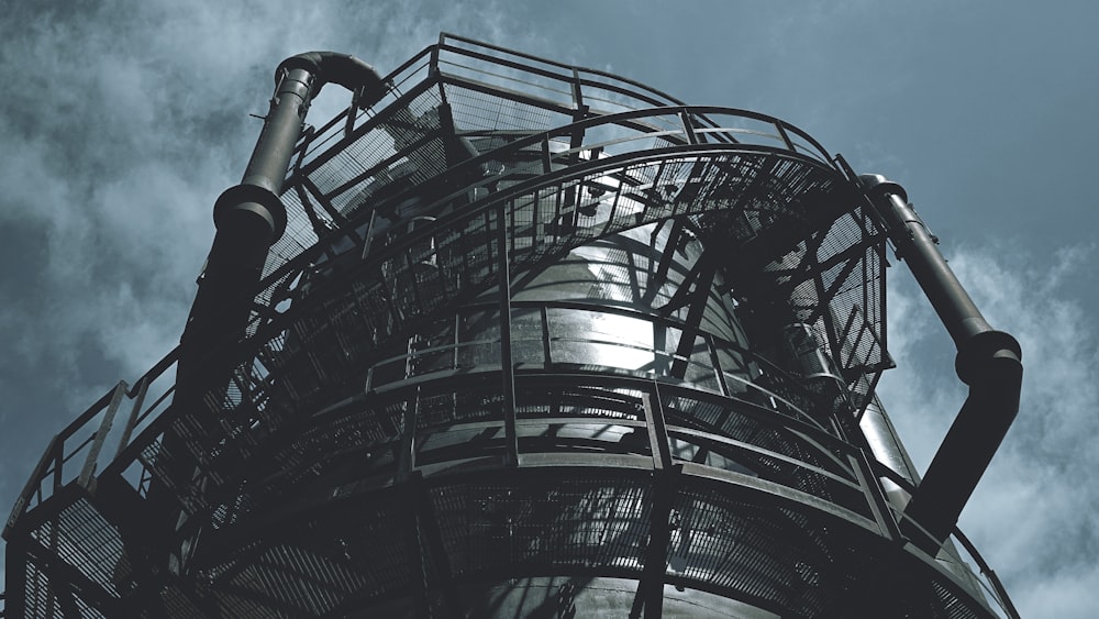 black metal spiral staircase under blue sky during daytime