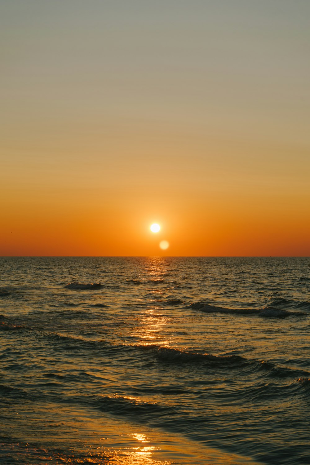 body of water during sunset