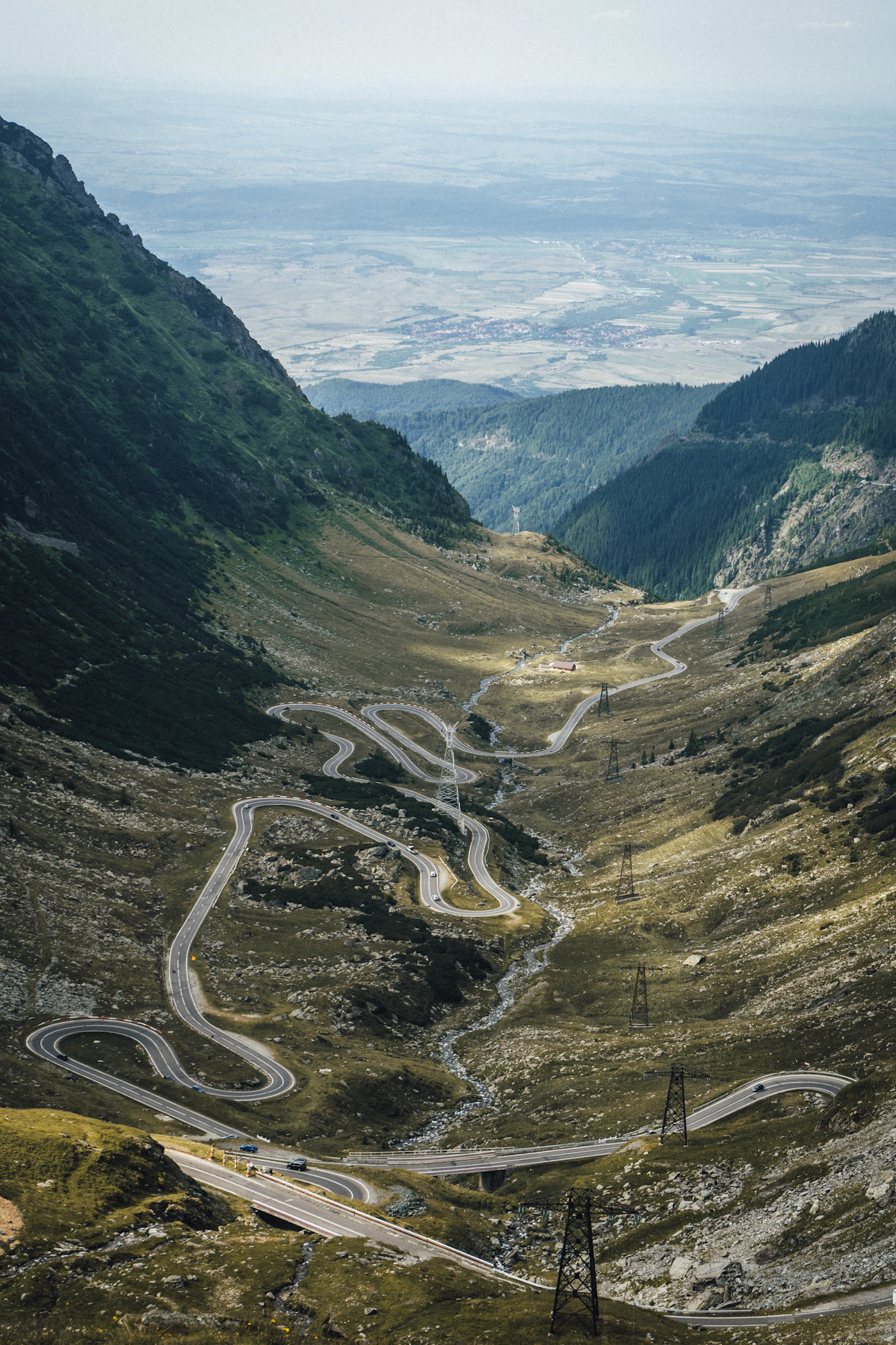 The Transfăgărășan road through a green mountain valley