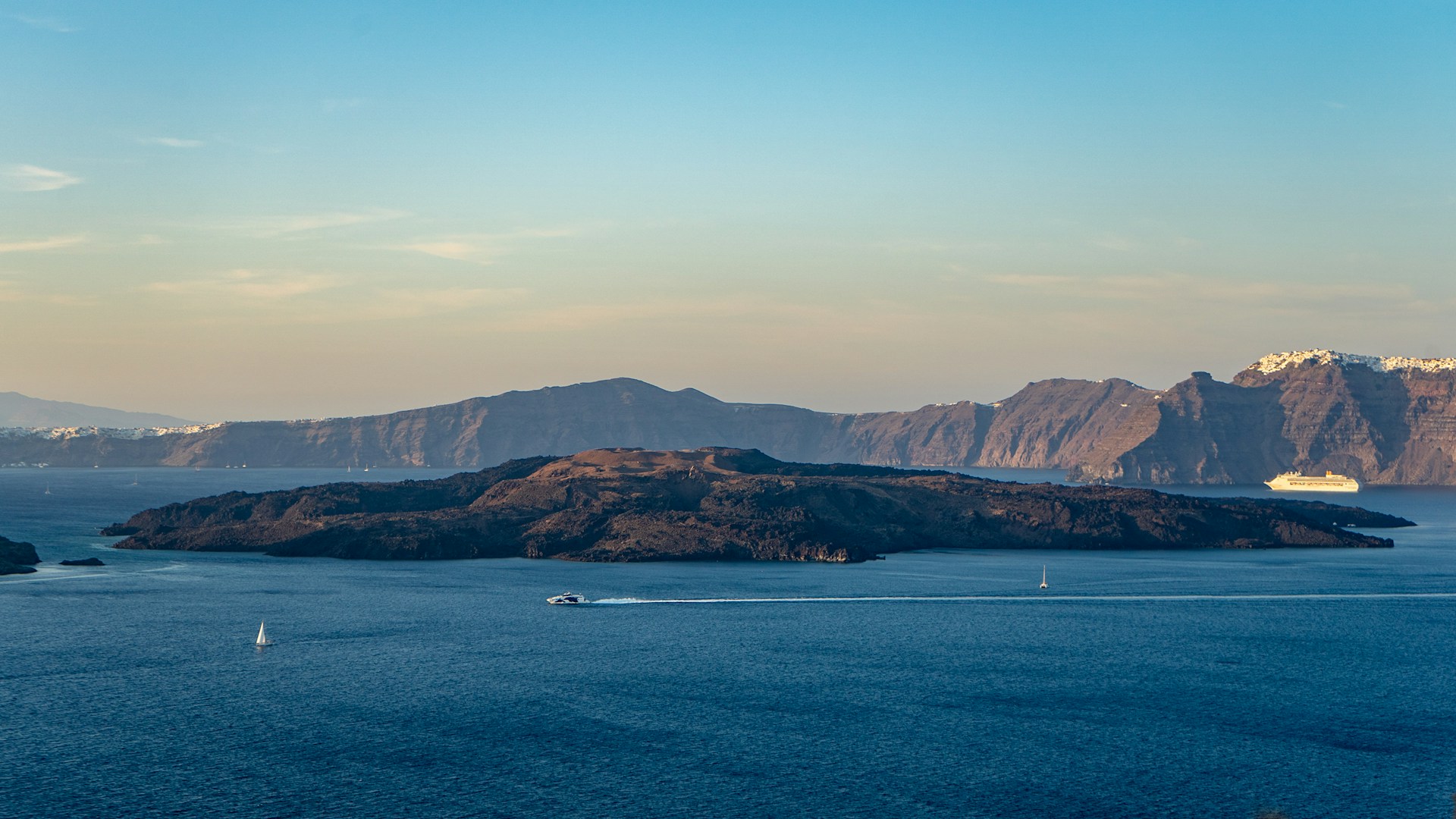 brown mountains near body of water during daytime